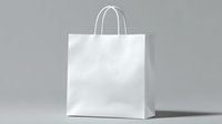 White paper shopping bag with handles on gray background, isolated mockup for branding and retail design presentation. Clean minimalist commercial packaging.