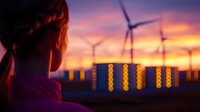 Young woman gazing at wind turbines and energy storage containers during dramatic purple and orange sunset, highlighting sustainable power generation and storage.