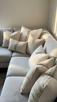 Modern neutral sectional sofa with textured throw pillows in cozy living room corner for home decor and interior design inspiration.