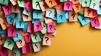Colorful sticky notes with question marks scattered on yellow background creating dynamic composition for business problem solving and FAQ concept.