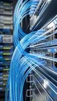 Fiber optic cables connected to server rack equipment in data center facility, representing network infrastructure, telecommunications, and high-speed internet connectivity.