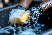 Frozen spoon with yellow liquid nitrogen smoke effect and ice crystals dripping, dramatic close up macro photography on dark background with wooden handle.