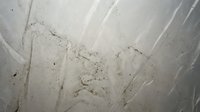 Cracked concrete wall surface with weathered texture and natural aging patterns showing structural wear and urban decay elements.
