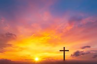 Christian cross silhouette against dramatic sunset sky with vibrant orange and purple clouds. Spiritual background symbolizing faith, hope and resurrection.