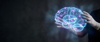 Hand holding glowing digital brain with neural networks and connections representing artificial intelligence, machine learning and futuristic technology concepts.
