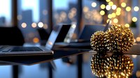 Golden heart decoration with bokeh lights reflecting on glossy surface near laptop, creating romantic evening atmosphere for remote work or holiday celebration.
