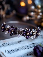 Elegant bridal tiara with deep purple crystal flowers and pearl accents resting on vintage sheet music, romantic wedding accessories in soft lighting.