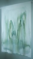 Abstract watercolor painting with flowing green and blue tones on white paper mounted on wall for modern interior design and contemporary art decoration.