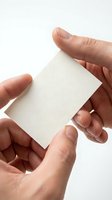Male hands holding blank white business card mockup on clean background for branding and corporate identity design projects.