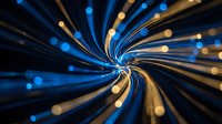 Abstract blue and gold light streaks radiating from center creating dynamic motion blur effect on dark background for technology and energy concepts.