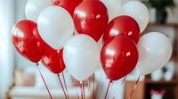 Festive red and white helium balloons floating together against blurred interior background, creating celebratory party atmosphere for special occasions.
