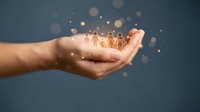 Cupped hands holding glowing human figures with magical light effects representing teamwork, community support, and human resources management.