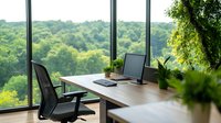 Modern workspace with panoramic forest view, wooden desk, ergonomic chair, computer monitor, and indoor plants creating natural work environment.