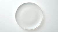 Empty white ceramic plate isolated on white background, ready for food photography, restaurant design, and culinary presentations.
