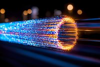 Glowing optical fiber strands with blue and orange light effects against dark background, showing data transmission and digital connectivity concept.