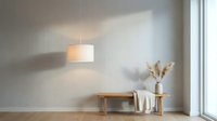 Minimalist interior with pendant lamp, wooden bench, white vase with dried pampas grass, and natural light from window. Suitable for home decor, design inspiration, and lifestyle content.