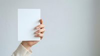 Hand holding blank white card against neutral background, suitable for business presentations, marketing mockups, and promotional designs.