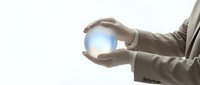 Businessman in formal suit holding glowing crystal ball with bright light, symbolizing future vision, innovation, and strategic planning for business success.