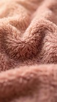 Soft pink fluffy blanket with cozy texture creates warm comfortable atmosphere for home decor and relaxation concepts.