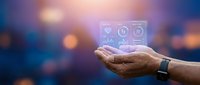 Healthcare technology concept with medical icons floating above open palm against blurred city lights background for digital health applications.