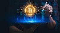 Businessman hand touching glowing bitcoin symbol with circuit board pattern and financial charts on digital tablet screen for cryptocurrency trading.