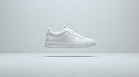 White leather low-top sneaker with minimalist design, isolated on neutral background. Suitable for footwear advertising, e-commerce, fashion catalogs, and athletic apparel marketing.