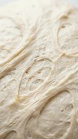 Creamy whipped frosting with swirled texture and air pockets, suitable for baking, dessert, and culinary content.