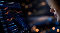 Young woman analyzing financial data visualization with glowing blue charts and orange market indicators on dark background with bokeh effect.