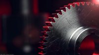 Industrial metal gear wheel with sharp teeth in dramatic red lighting for manufacturing and engineering concepts.