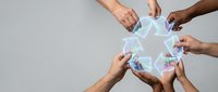 Diverse hands holding glowing network star symbol together against neutral background, representing teamwork, collaboration, connection, and shared success in business and community projects.