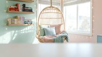 Cozy reading nook with hanging rattan chair, mint green shelves, soft pillows and natural light streaming through windows creating peaceful home interior.
