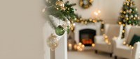 Cozy living room with Christmas tree, fireplace and holiday decorations creating warm festive atmosphere for seasonal celebrations and winter gatherings.