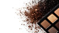Scattered loose brown eyeshadow powder and professional makeup palette with metallic and shimmer shades on white background, cosmetic flatlay composition.