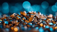 Shimmering copper and orange butterfly wings scattered on dark background with dreamy turquoise bokeh lights creating magical atmosphere.