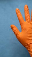 Close-up of an orange latex glove hand against a blue background, suitable for healthcare, safety, medical, and hygiene-related design projects.