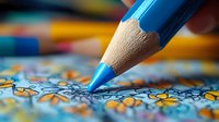 Blue wooden pencil drawing on floral patterned fabric with colorful pencils in soft focus background, macro close up view showing texture and detail.