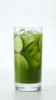 Refreshing green cucumber lime iced drink in a tall glass on white background, perfect for healthy beverage menus and detox concepts.