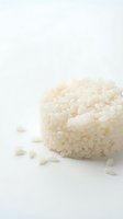 Pile of cooked white rice grains isolated on clean white background, suitable for food packaging, culinary websites, nutrition guides, and restaurant menus.