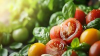 Fresh cherry tomatoes in red and yellow with water drops and basil leaves, macro shot with soft natural lighting and shallow depth of field for food photography.