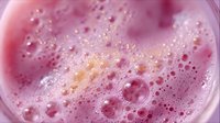 Pink bubbles and foam texture with soft blurred background creating abstract macro photography pattern, suitable for wellness and cosmetic industry backgrounds.