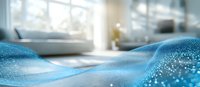 Soft waves of blue glittering fabric create dynamic flowing curves against blurred bright interior background, adding luxurious textile movement and sparkle effect.