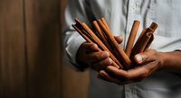 Artisan baker or chef holding fresh baked breadsticks and ciabatta rolls in hands, showcasing homemade bakery products for culinary and food service use.