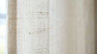 Natural linen fabric texture with rustic weave pattern and organic fibers, soft beige neutral tones for interior design and textile backgrounds.