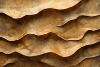 Abstract wavy sandstone texture with natural ripple patterns and rough surface creating dramatic light and shadow effect in warm earth tones.
