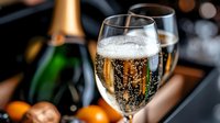 Elegant champagne glass filled with sparkling wine and bubbles next to bottle, perfect for celebrations, New Year, weddings and festive occasions.