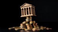 Classical temple building balanced on stack of golden coins representing financial stability and banking investment growth on dark background.