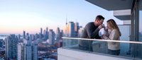 Couple enjoying romantic moment on high-rise balcony overlooking illuminated city skyline at sunset, urban romance and luxury lifestyle concept for travel and relationship themes.