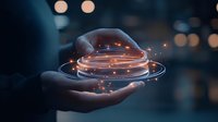 Glowing digital sphere with orbiting light trails floats above open hand against dark background with bokeh lights, representing future technology and innovation.
