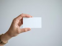Hand holding blank white business card on isolated background, suitable for branding, corporate identity, and marketing mockup designs.
