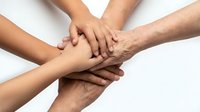 Diverse group of people stacking hands together in unity, teamwork and collaboration gesture against white background for corporate and community projects.